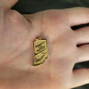 Vintage Indiana State map charm features engravings of the Indianapolis 500 race